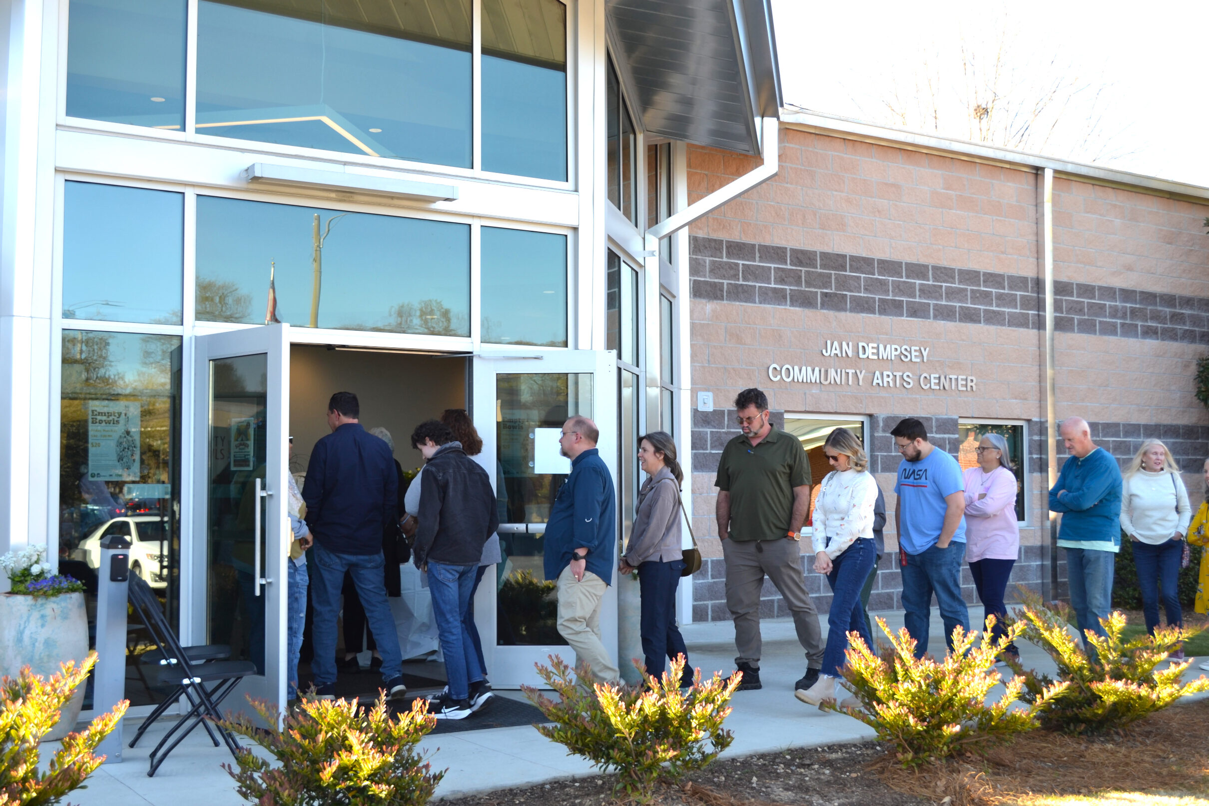 Image shows people lined up waiting to enter the event.