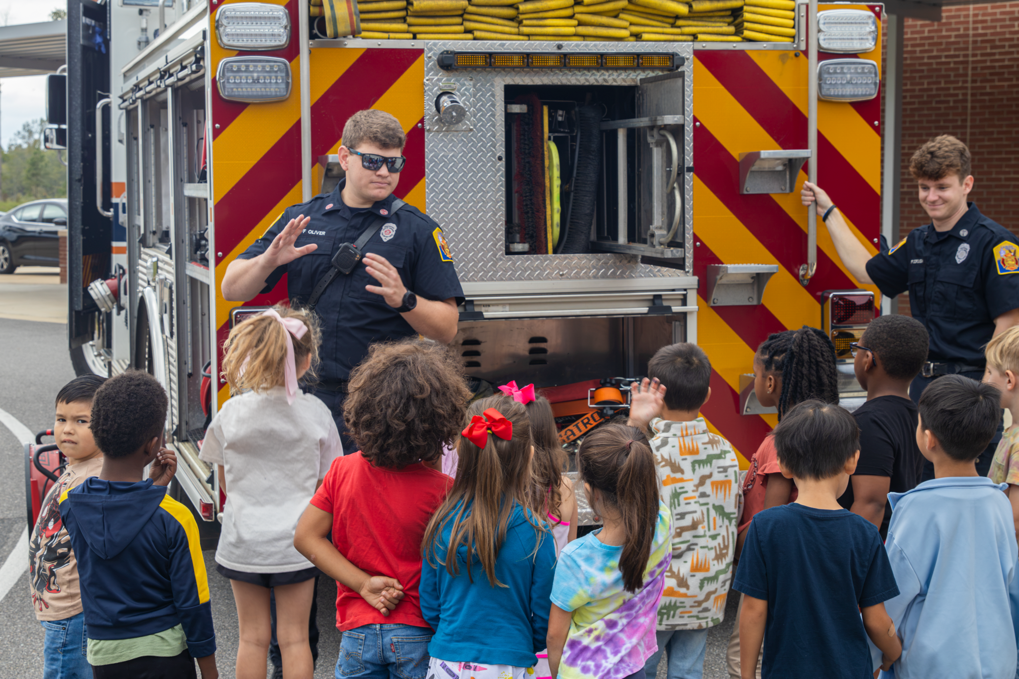 Firefighter talking to children