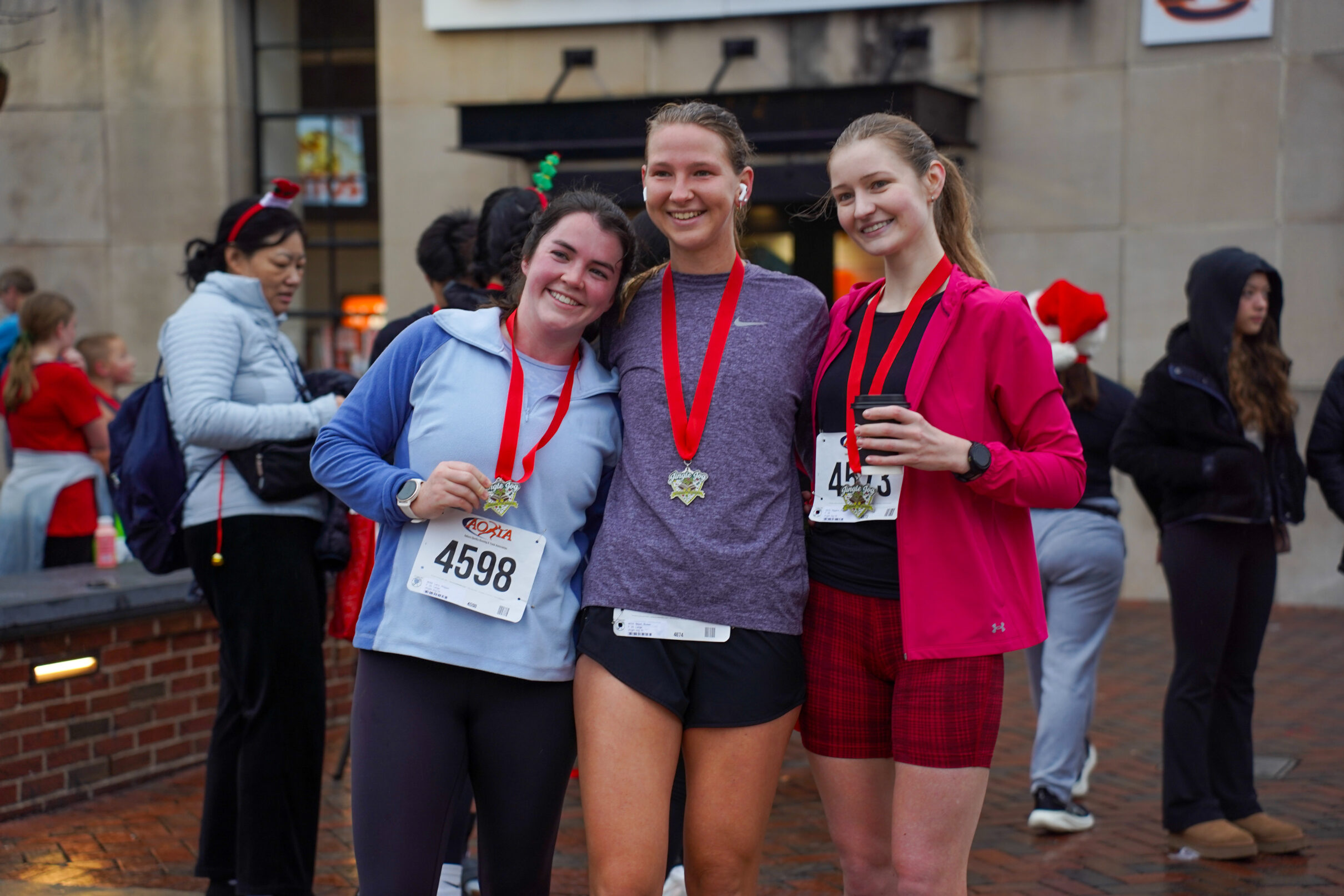 A group of race finishers holding their medals.