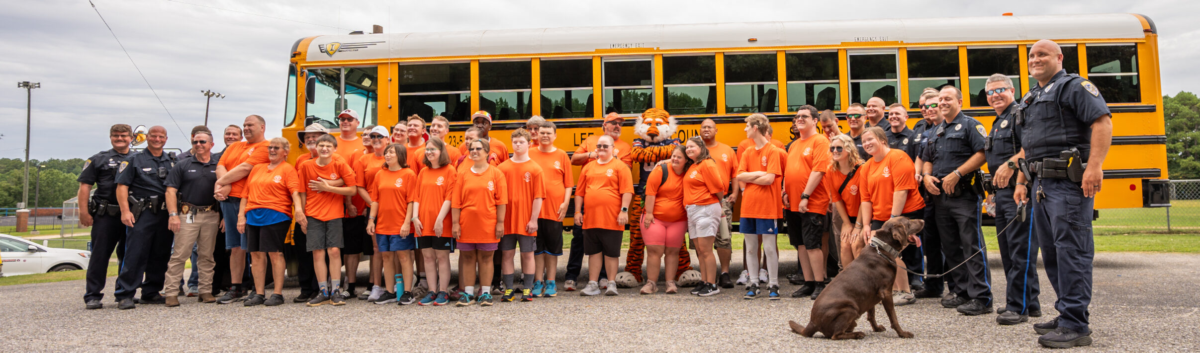 Special Olympic athletes posing for a group picture with police officers and Aubie.