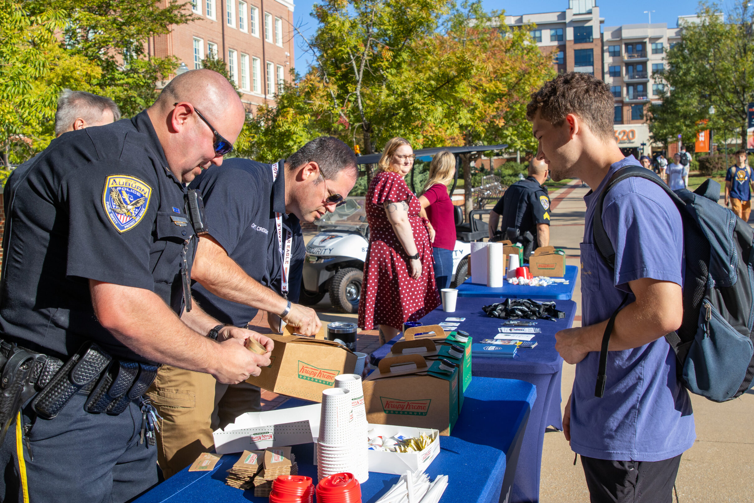 Officers pouring coffee for university student