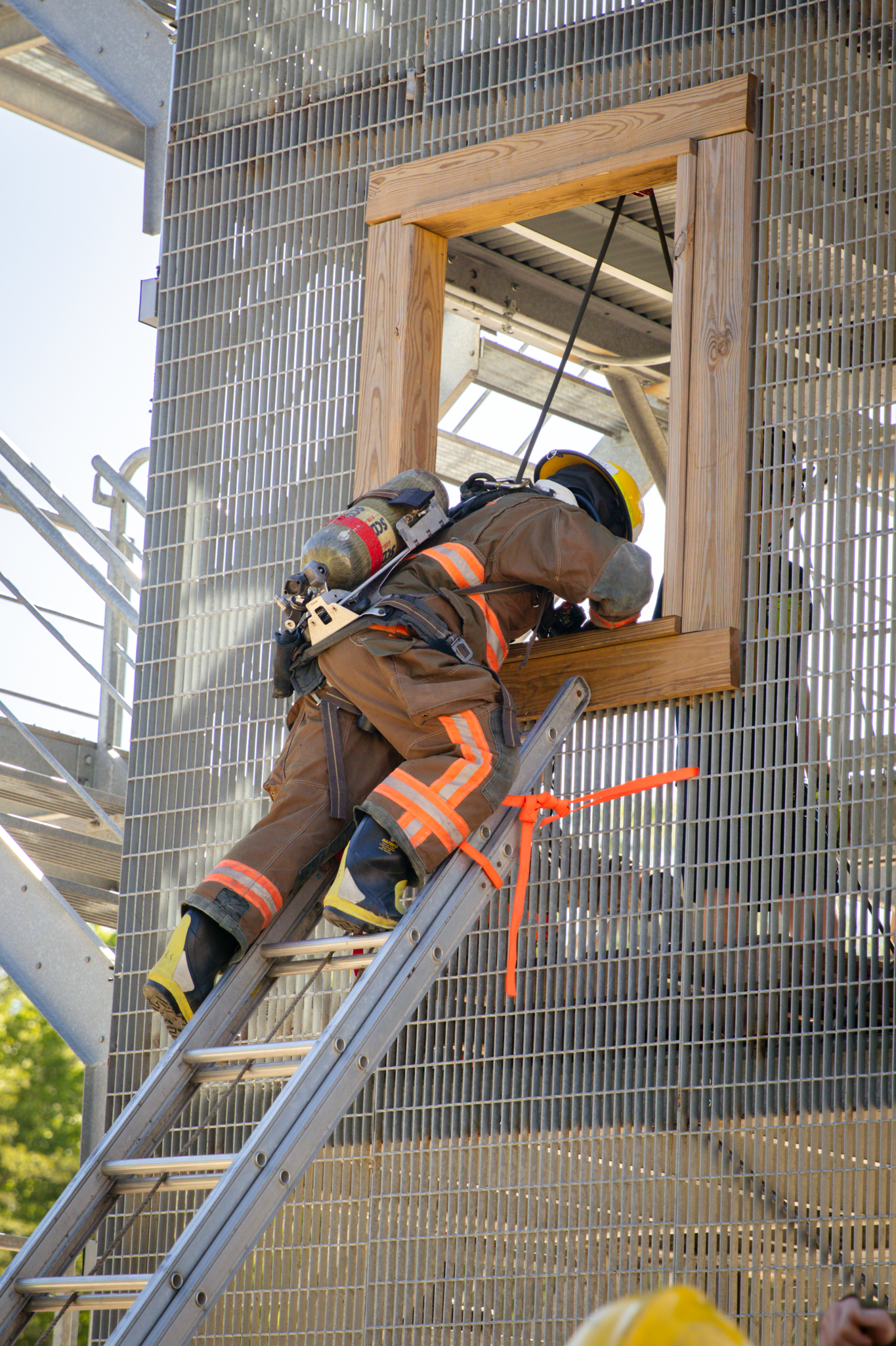Firefighter recruit climing through window
