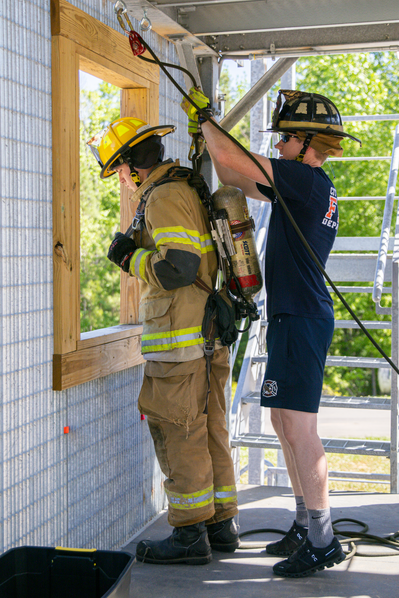 Firefighter getting hooked onto a line